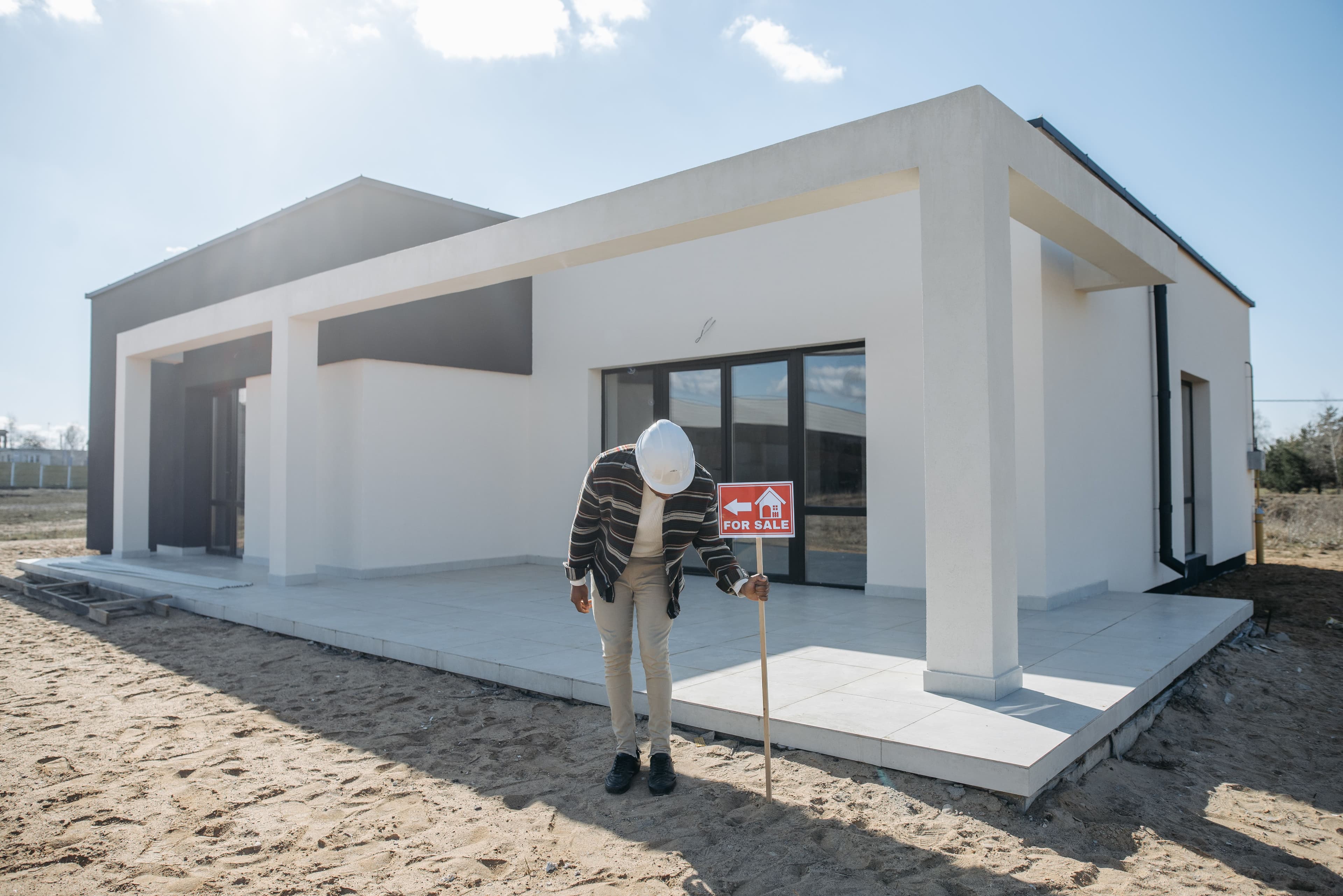 Newly completed home with a for-sale sign on site